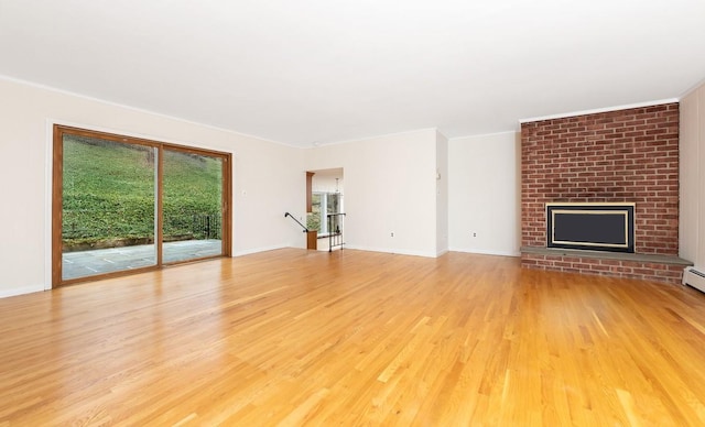 unfurnished living room featuring a brick fireplace and light wood-type flooring