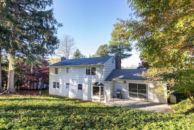 back of house featuring a yard and a patio area