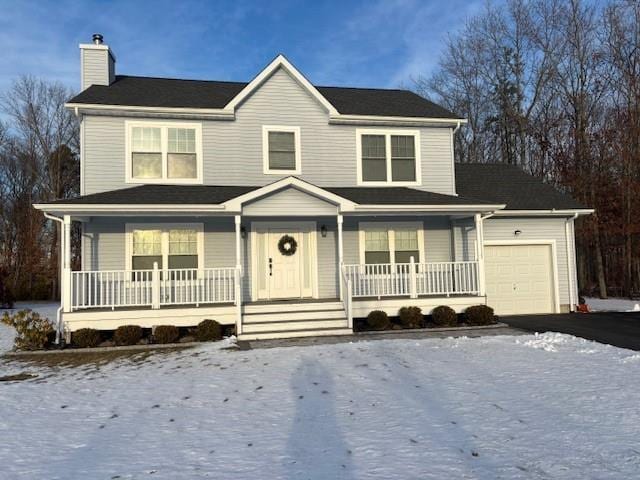 view of front facade with a garage and covered porch