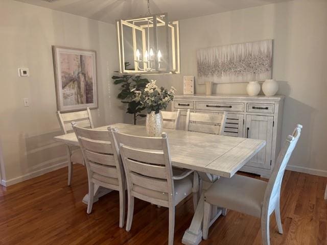 dining space featuring a notable chandelier and dark hardwood / wood-style floors