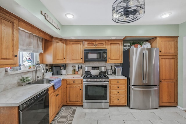 kitchen with sink, decorative backsplash, black appliances, and light tile patterned floors