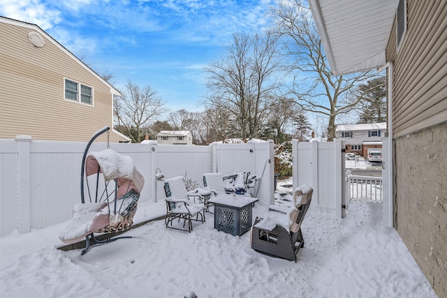 yard layered in snow with an outdoor fire pit