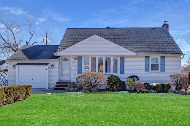 view of front of property featuring a garage and a front yard