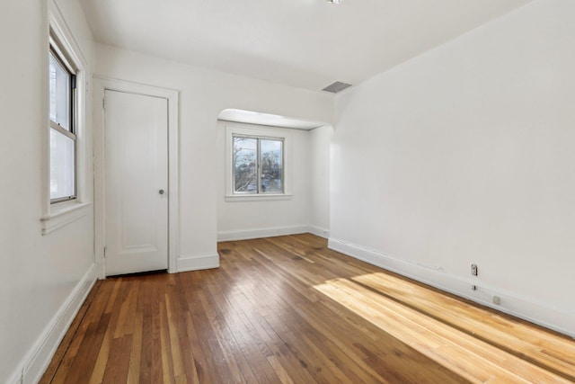 unfurnished bedroom with dark hardwood / wood-style flooring