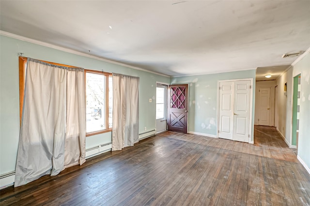 spare room with dark hardwood / wood-style flooring, a baseboard heating unit, and ornamental molding