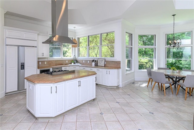 kitchen featuring white cabinetry, island range hood, paneled built in fridge, and a kitchen island