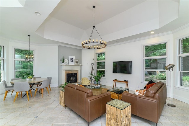 tiled living room featuring a notable chandelier, crown molding, and a raised ceiling