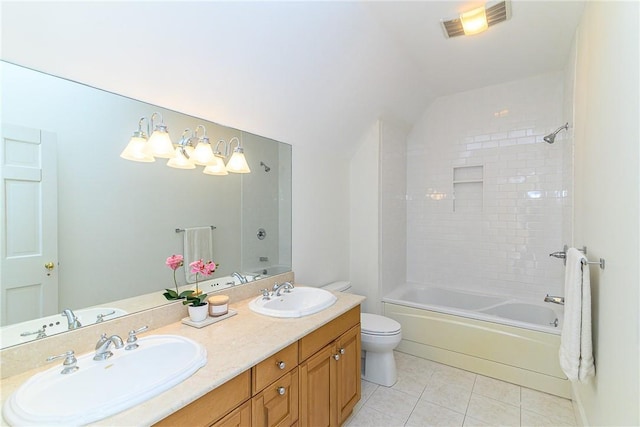 full bathroom with tiled shower / bath combo, vanity, tile patterned floors, and toilet