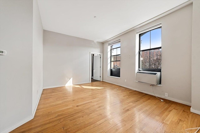 empty room with light hardwood / wood-style flooring