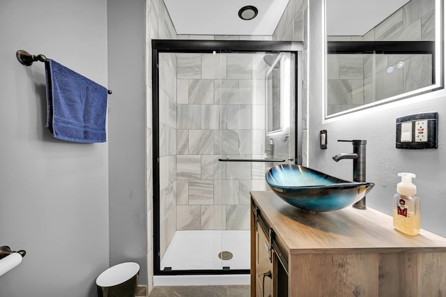 bathroom featuring a shower stall and vanity