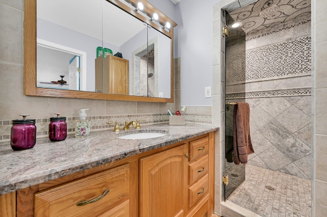 full bathroom with a shower stall and vanity