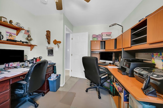 home office featuring ceiling fan, concrete floors, and baseboards