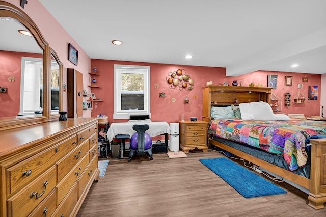 bedroom with wood finished floors and recessed lighting