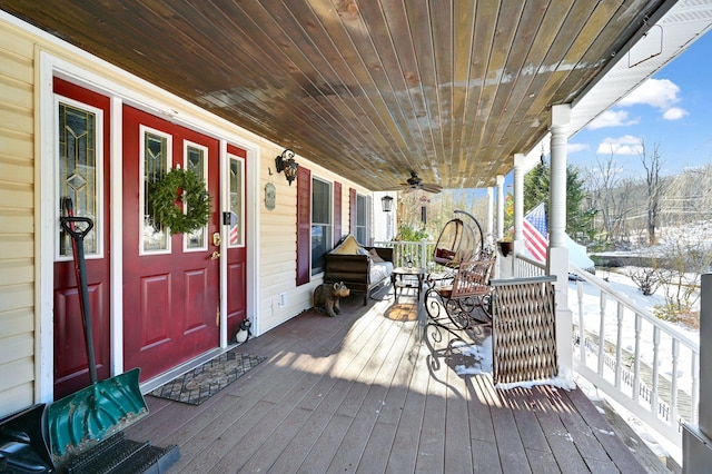 wooden terrace with a porch and ceiling fan