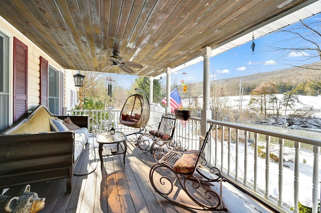 wooden terrace with a ceiling fan