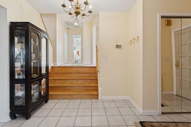 entryway with an inviting chandelier and light tile patterned floors