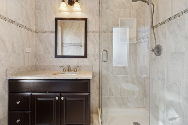 bathroom featuring vanity and a shower with door