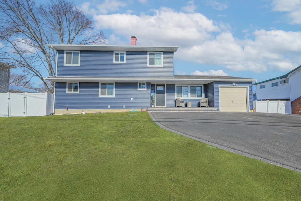 view of front of home featuring a garage and a front lawn