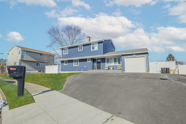 view of front of home with a garage and a front yard