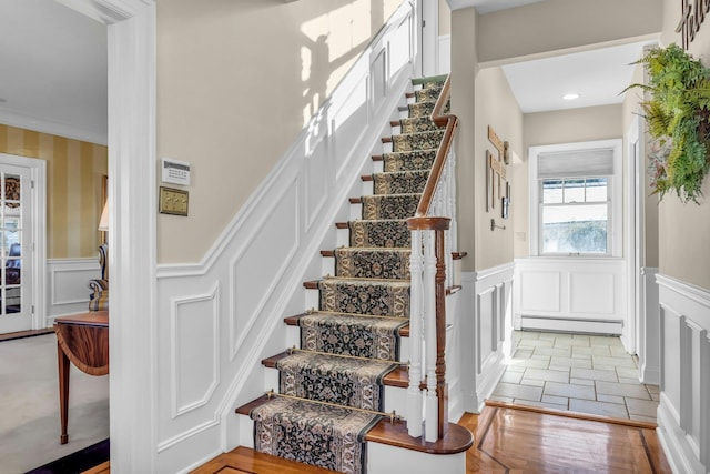 stairway featuring a baseboard radiator and tile patterned floors