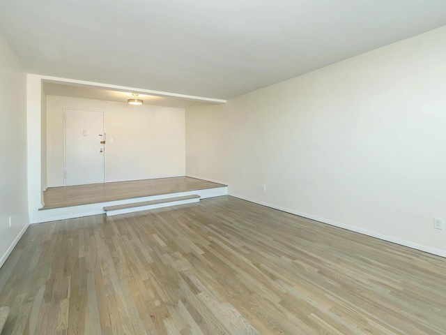 spare room with light wood-type flooring