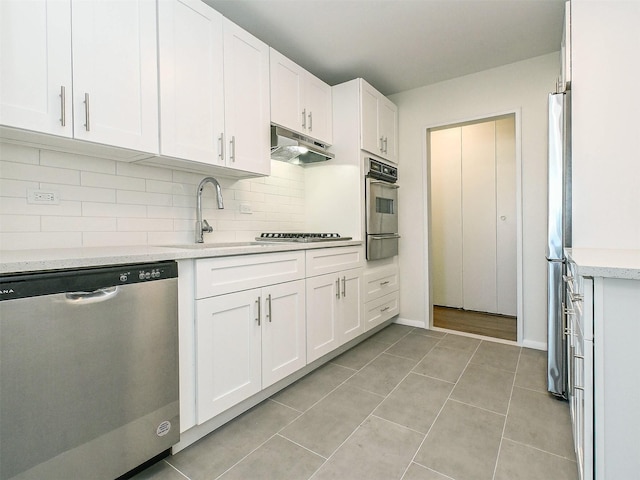 kitchen featuring white cabinetry, stainless steel appliances, sink, and decorative backsplash