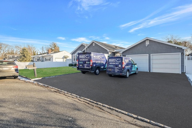 ranch-style home with a garage and a front lawn