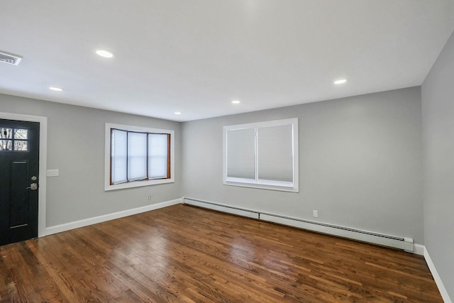 foyer entrance featuring baseboard heating and dark hardwood / wood-style flooring