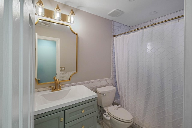 bathroom featuring tile walls, vanity, toilet, and walk in shower