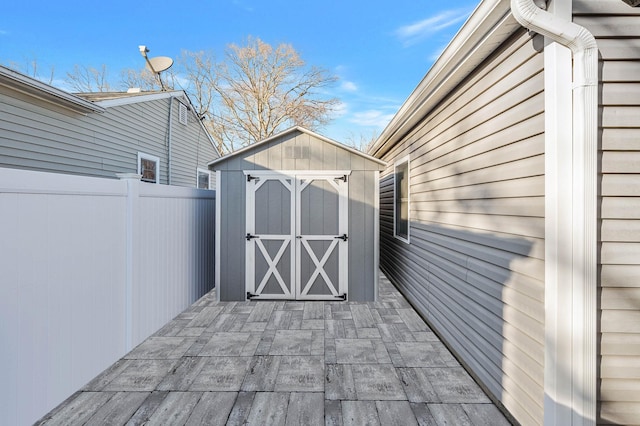 deck with a patio and a storage unit