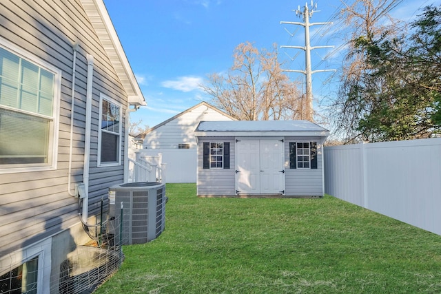 exterior space with central AC unit and a lawn