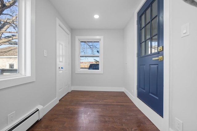 entryway with dark hardwood / wood-style flooring and a baseboard radiator