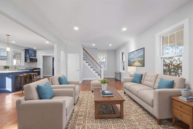 living room featuring sink and light wood-type flooring