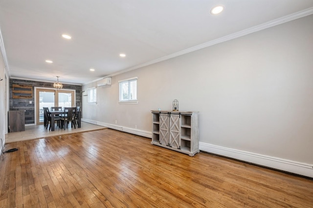 unfurnished living room with a baseboard radiator, ornamental molding, a wall mounted AC, and light hardwood / wood-style flooring