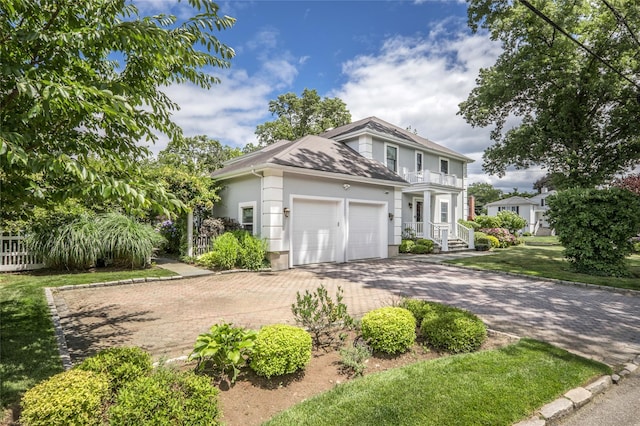 view of front of home with an attached garage, decorative driveway, and stucco siding