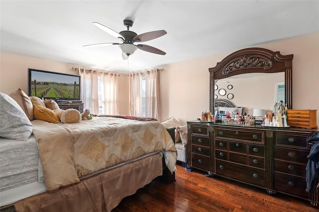 bedroom with dark hardwood / wood-style flooring and ceiling fan