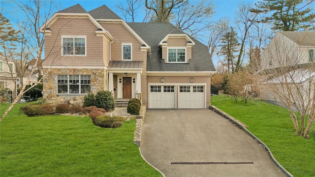 view of front of house with a garage and a front lawn