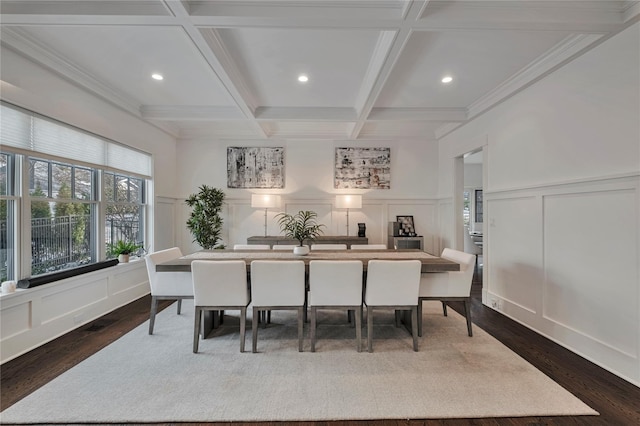 dining area with beamed ceiling, dark hardwood / wood-style floors, ornamental molding, and coffered ceiling