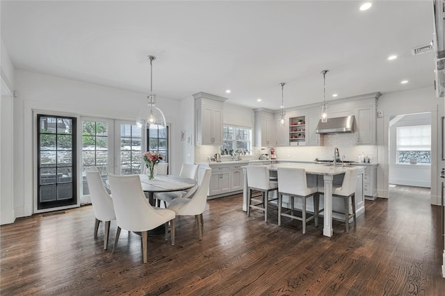 dining area with dark hardwood / wood-style floors