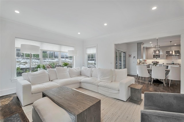 living room featuring ornamental molding and light wood-type flooring