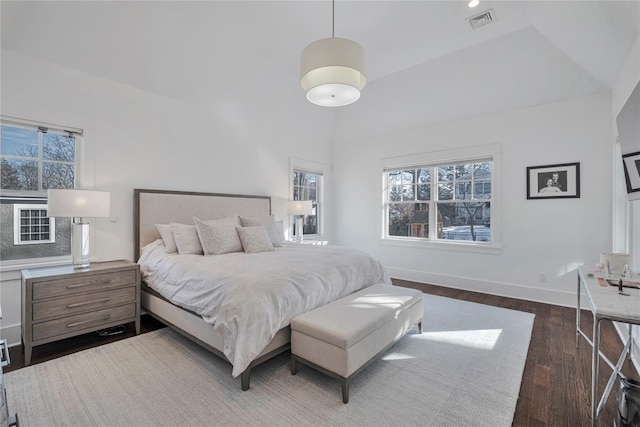 bedroom featuring lofted ceiling and dark hardwood / wood-style floors