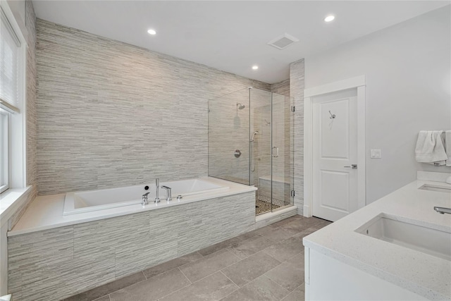 bathroom with vanity and independent shower and bath