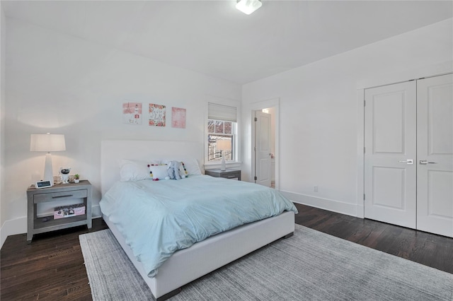 bedroom featuring dark hardwood / wood-style flooring and a closet