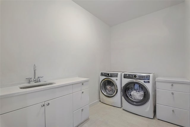 laundry area with cabinets, sink, and washer and dryer