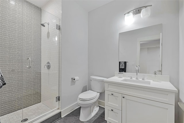 bathroom with a shower with door, vanity, tile patterned flooring, and toilet