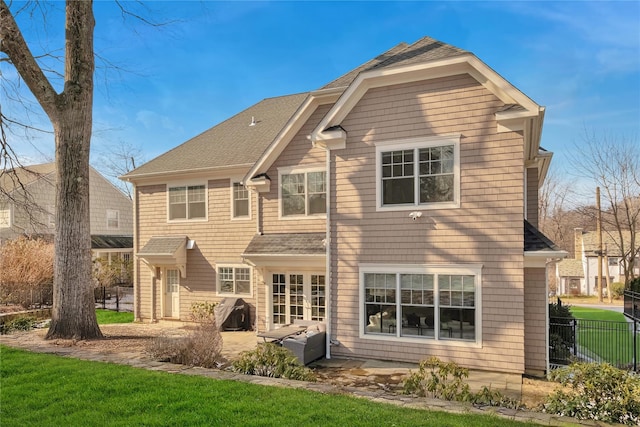 rear view of house featuring french doors, a yard, and a patio