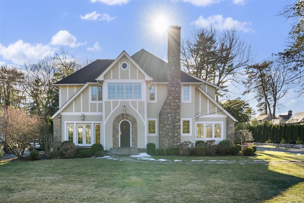 42 Fenimore Rd, Scarsdale, NY 10583 - tudor-style house featuring stone siding, a chimney, stucco siding, and a front yard
