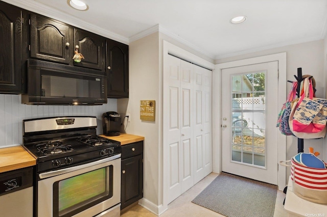 kitchen with crown molding, stainless steel appliances, and wooden counters