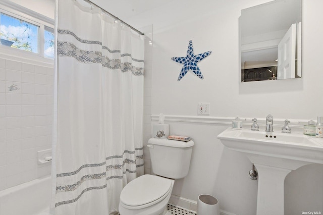 bathroom with toilet and shower / bath combo with shower curtain