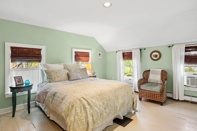 bedroom with hardwood / wood-style flooring, lofted ceiling, baseboard heating, and cooling unit